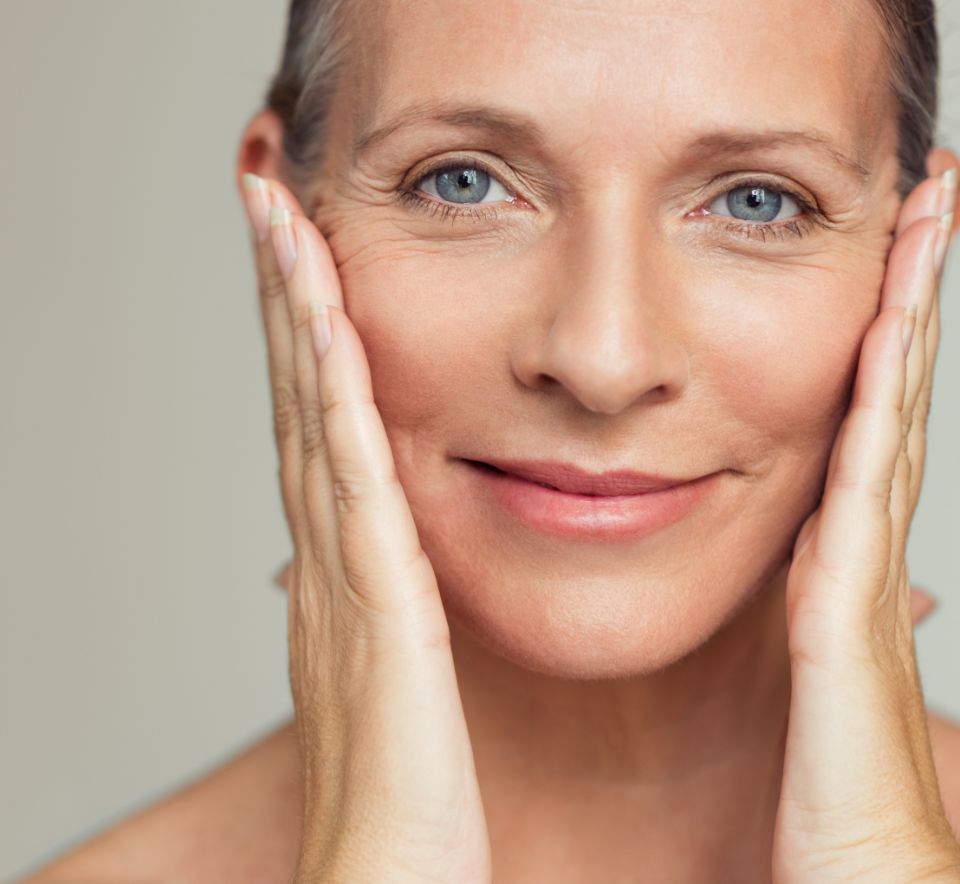 mature woman touching her face