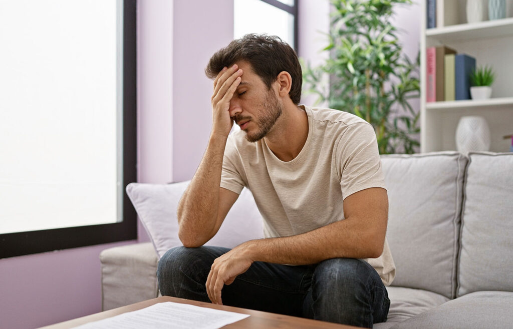 Man touching his head